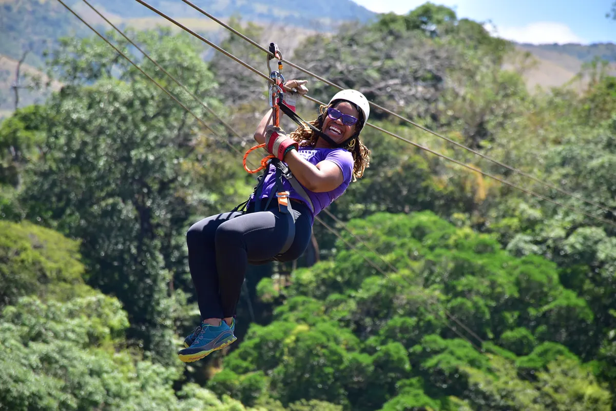 Woman ziplining through Costa Rica forest during the WANTED Woman Escape