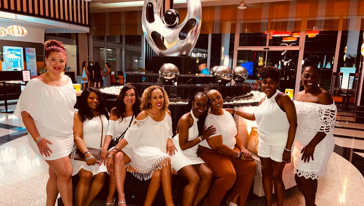 Women dressed in white celebrating together during the WANTED Woman Escape evening event