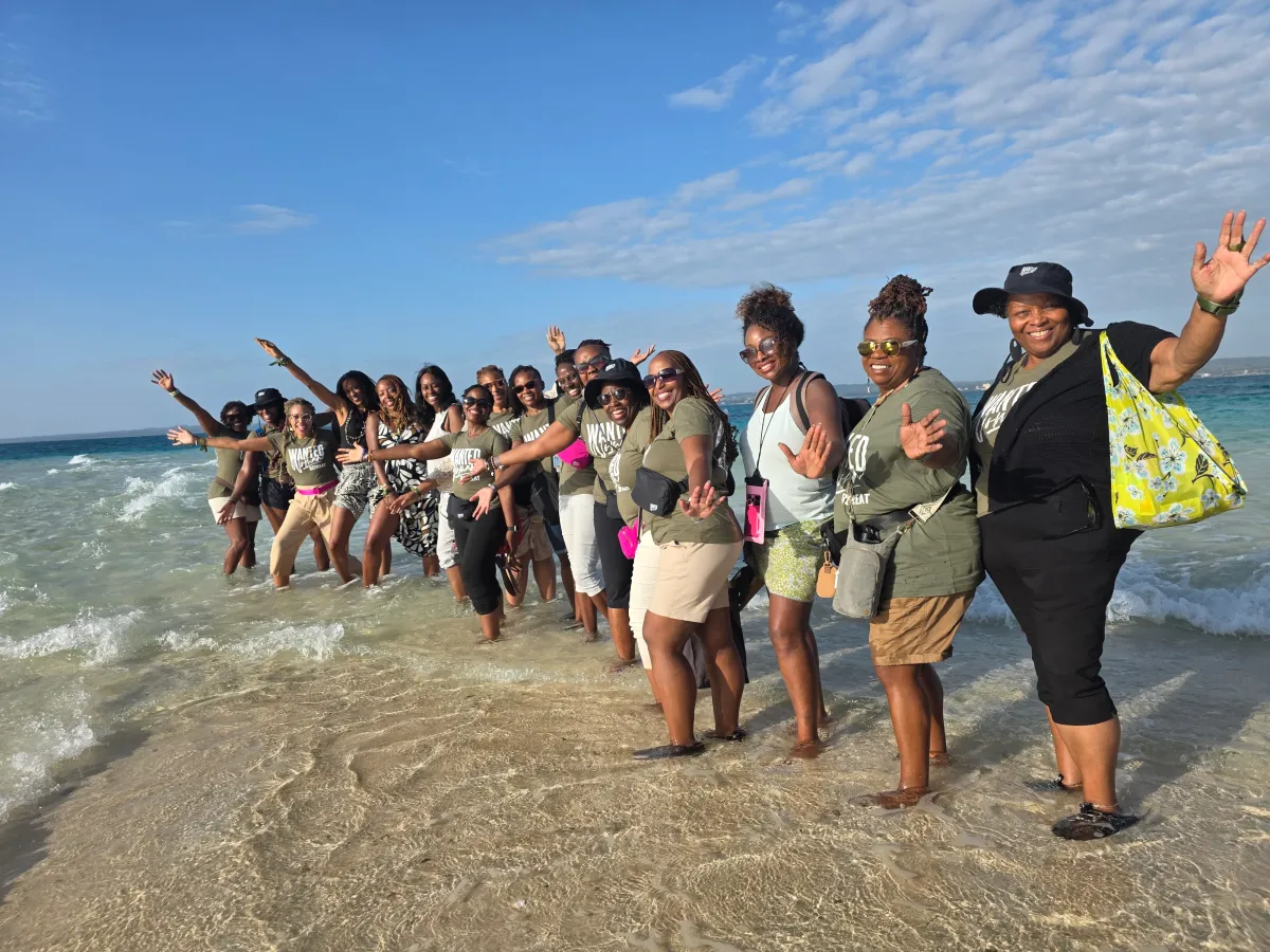 group of women dancing in ocean during Zanzibar retreat