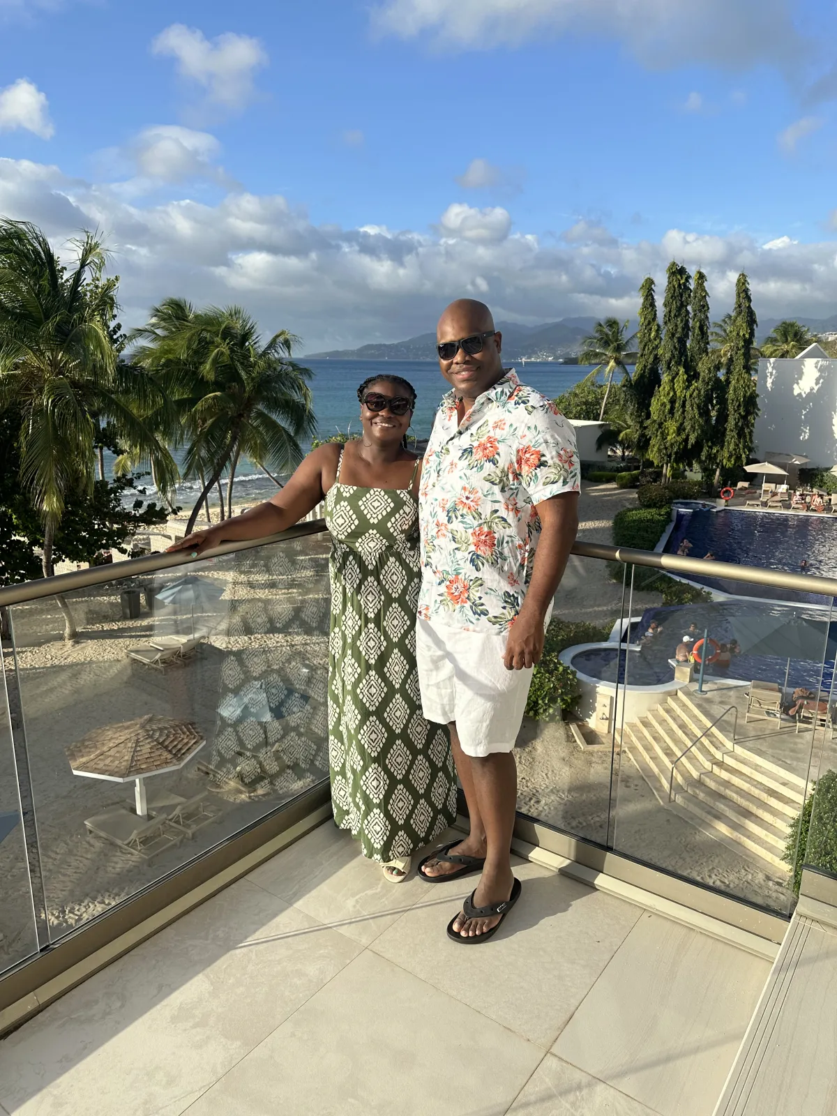 couple on balcony overlooking tropical resort during retreat
