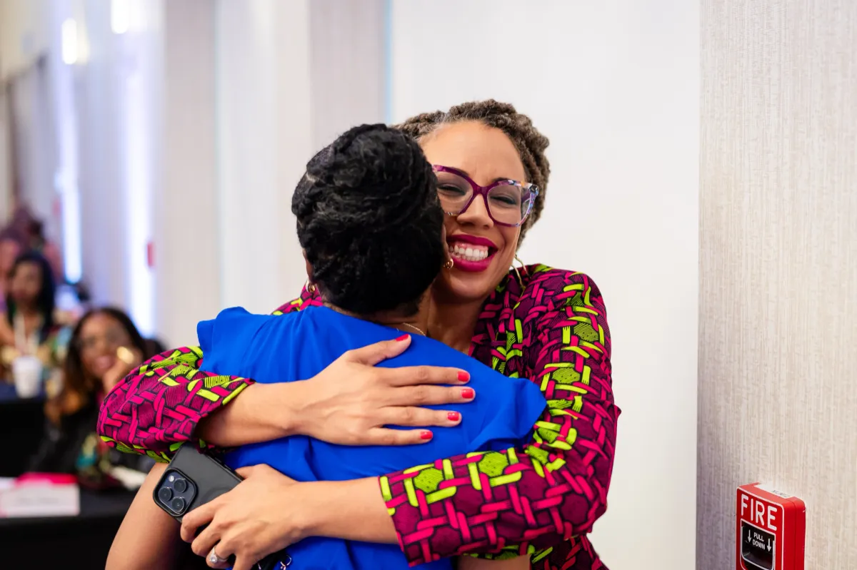 Black women hugging at WANTED Woman Live emotional moment