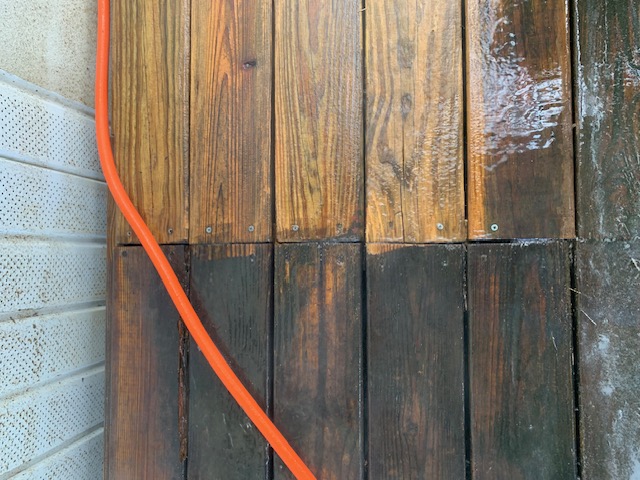 Cleaning concrete surface with pressure washer