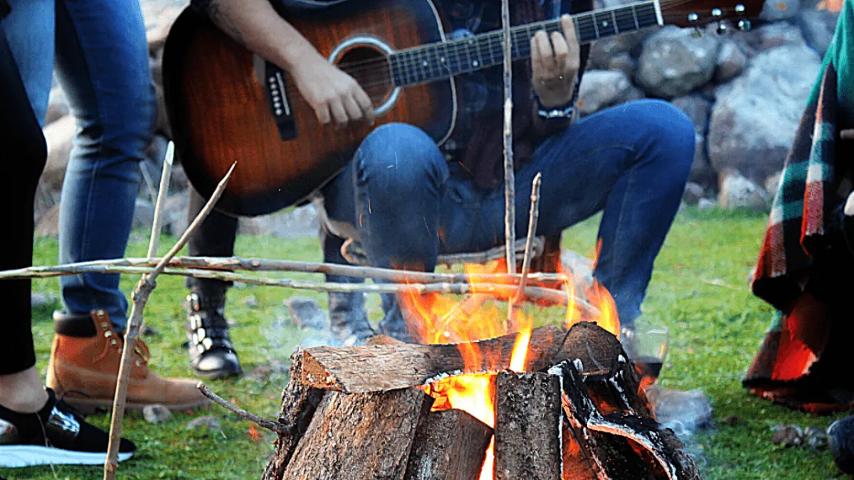 Playing songs on a guitar around the campfire on the Gold Coast