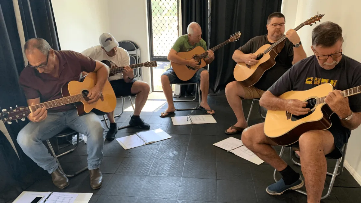 Adults practicing guitar