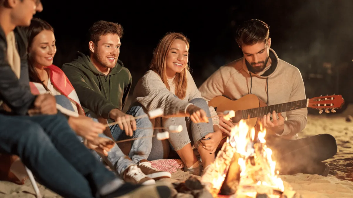 playing songs around a campfire with friends on the Gold Coast