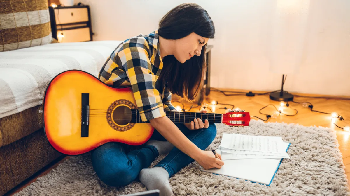 beginner guitarist practicing a song she loves