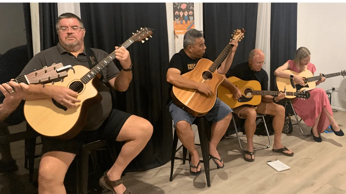 Adults on the Gold oast having fun playing songs