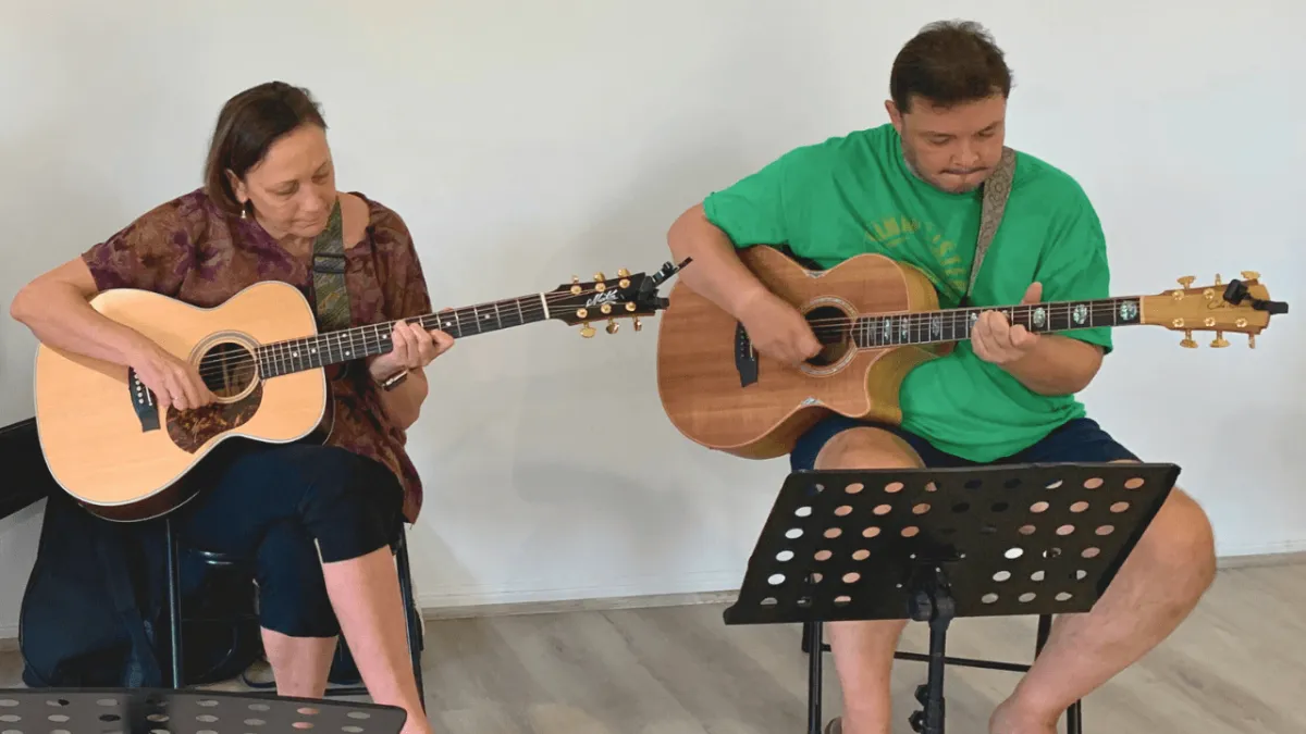 Small group guitar class for adults on the Gold Coast learning to strum