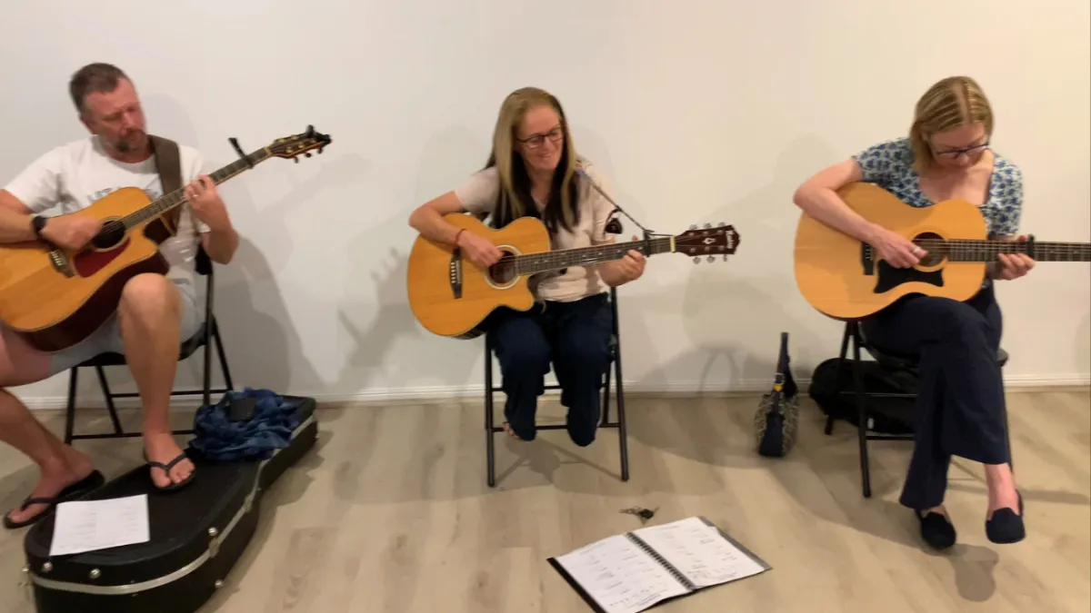 Female playing her guitar and loving the free intro session