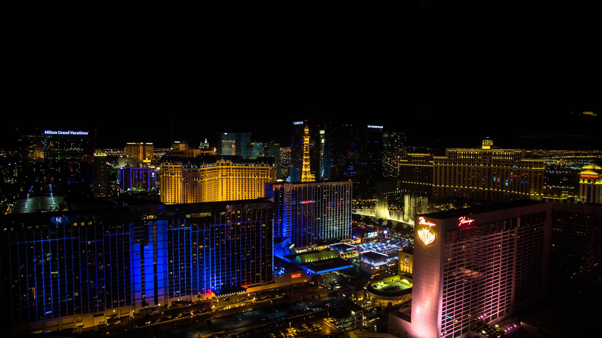 Private balcony suite at MGM Signature Las Vegas overlooking the Strip skyline at sunset with city lights and palm-lined pools below
