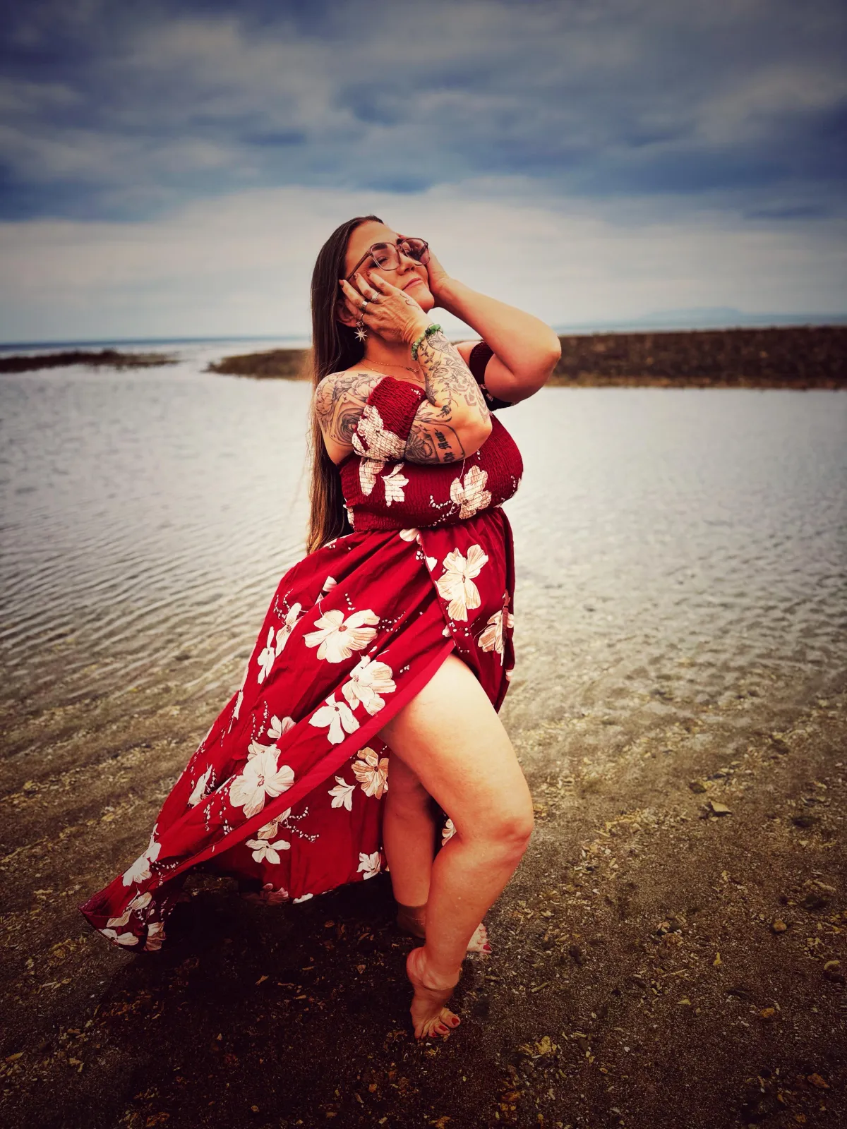 woman in white long sleeve shirt standing on seashore