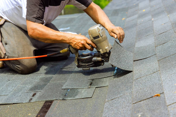 two men working on the roof of a house