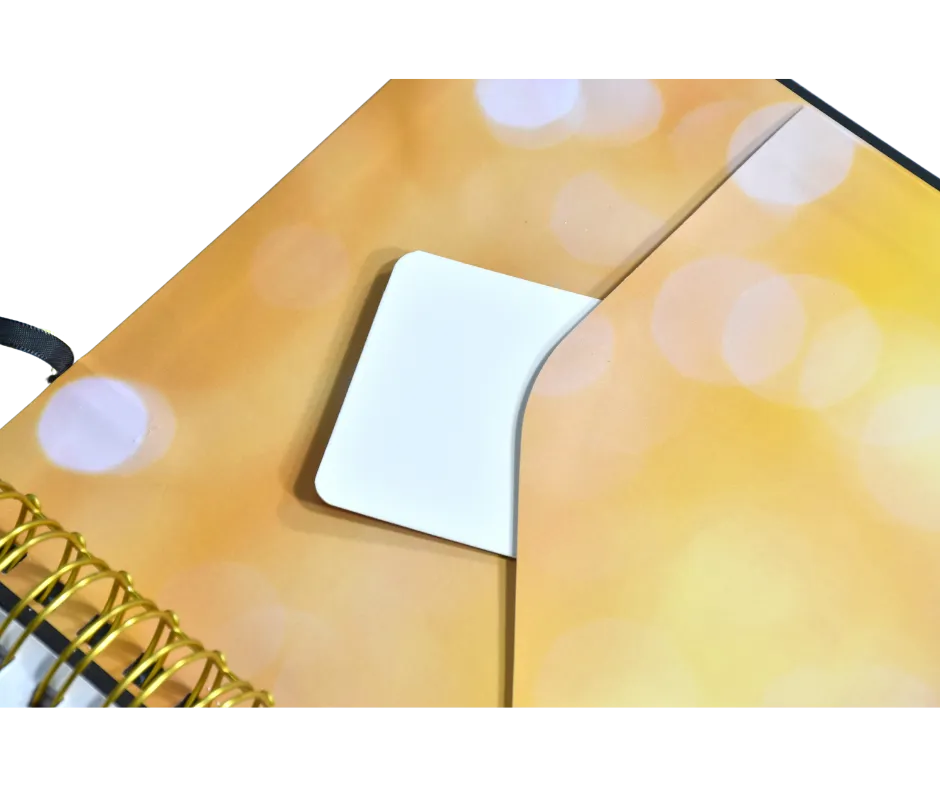 A beige spiral planner presented with an open black presentation box