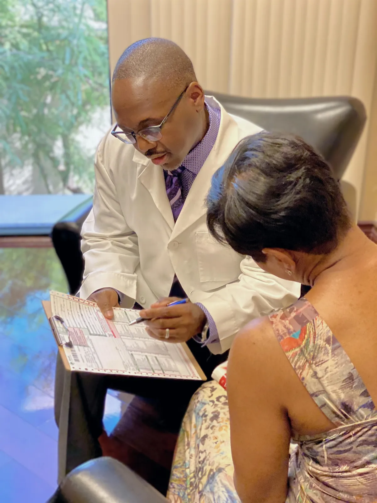 Dr. Wells explaining lab results to a patient