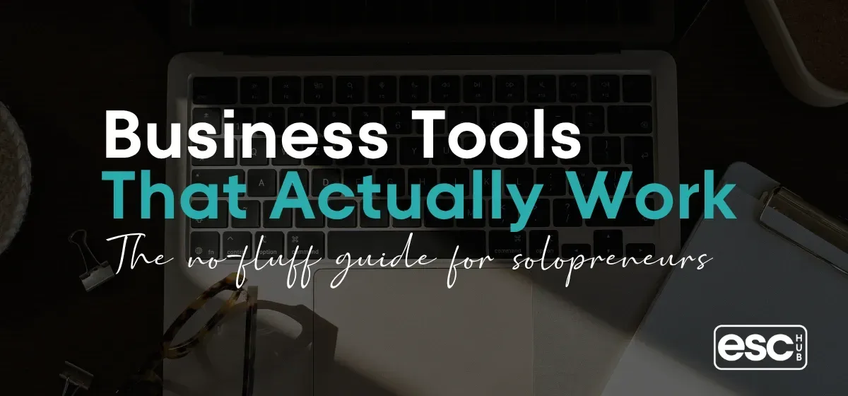 Clean minimal desk with laptop and plants - best business tools for small business owners