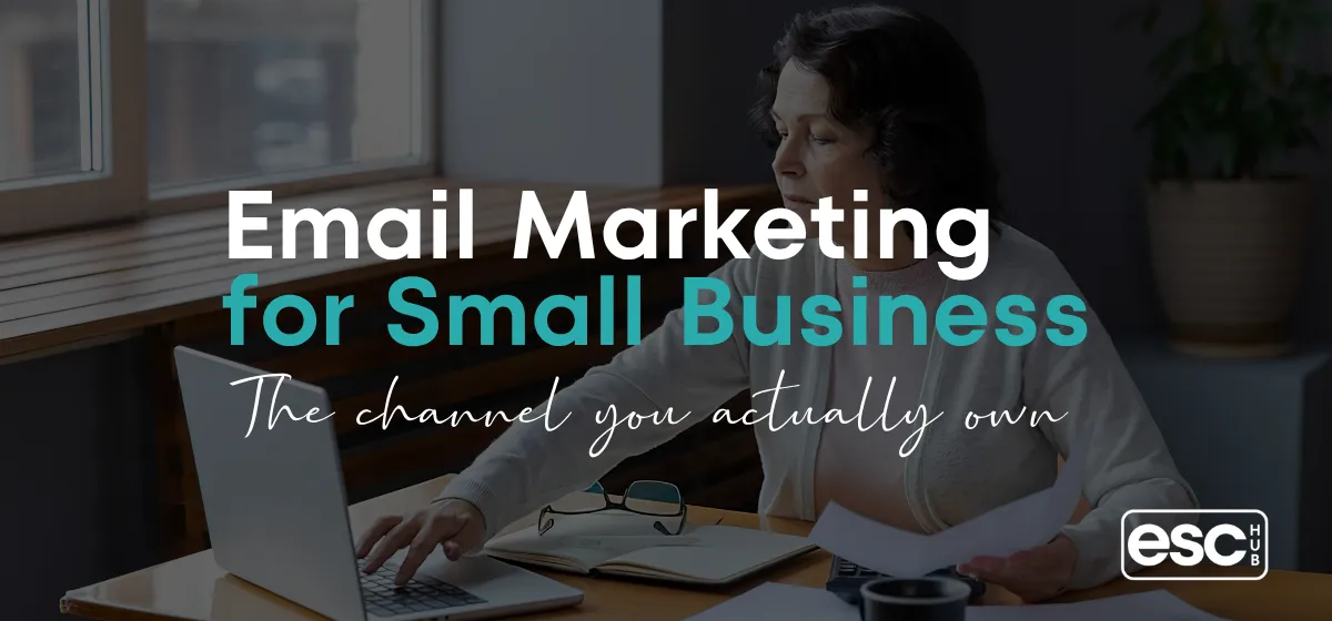 Woman working on laptop at cafe window - email marketing for small business owners guide