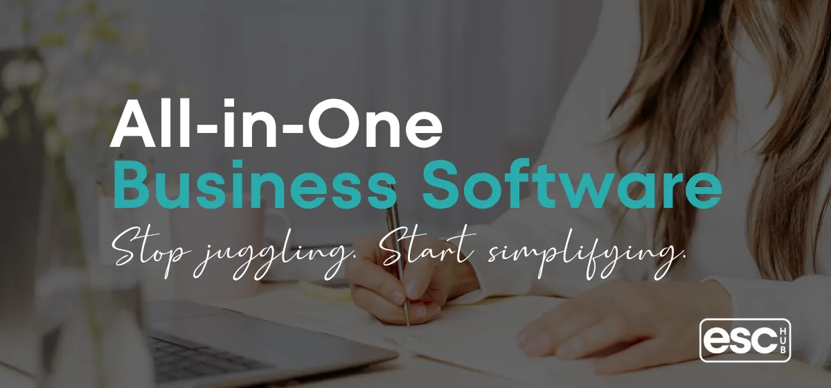 Woman working at bright minimal desk with laptop - all-in-one business software for solopreneurs guide