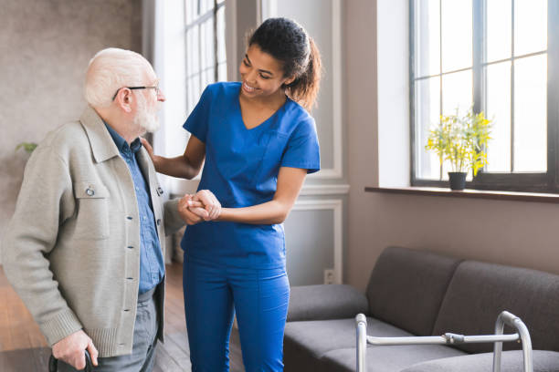 Doctor consults with an elderly patient on a couch.