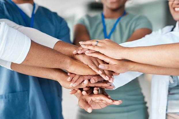 Elderly man with a warm smile in a living room.