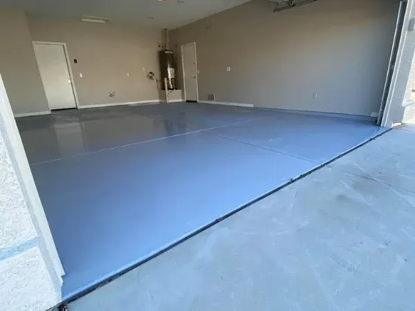 Freshly completed epoxy garage floor coating with a smooth, durable finish inside a clean two-car garage.