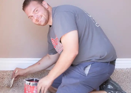 man brushing floor