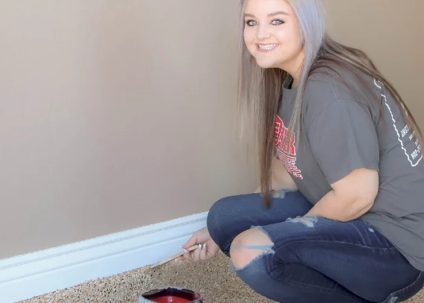 a girl applying epoxy floor coating
