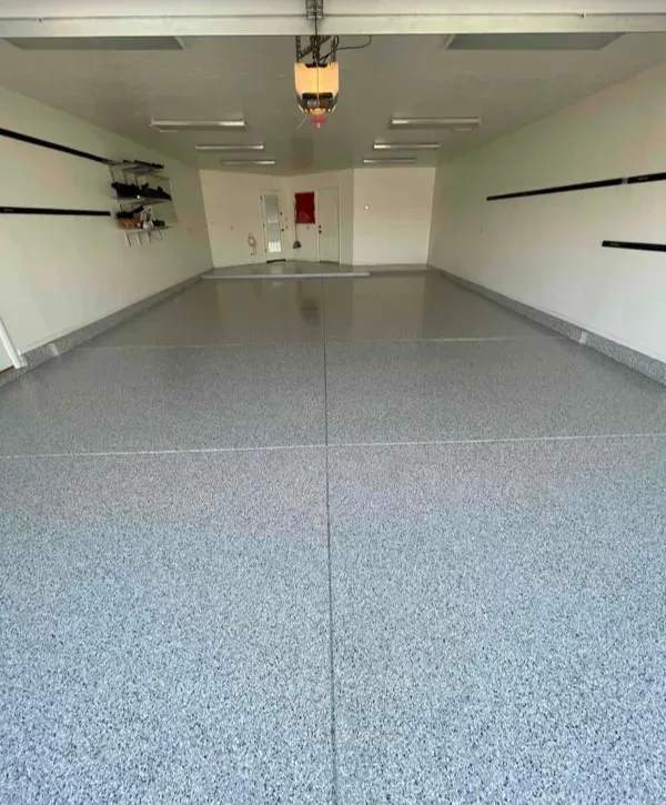 Clean gray flake epoxy coating in a two-car garage