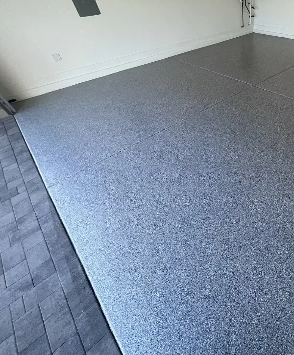 Glossy epoxy garage floor coating reflecting light in a clean, modern garage.