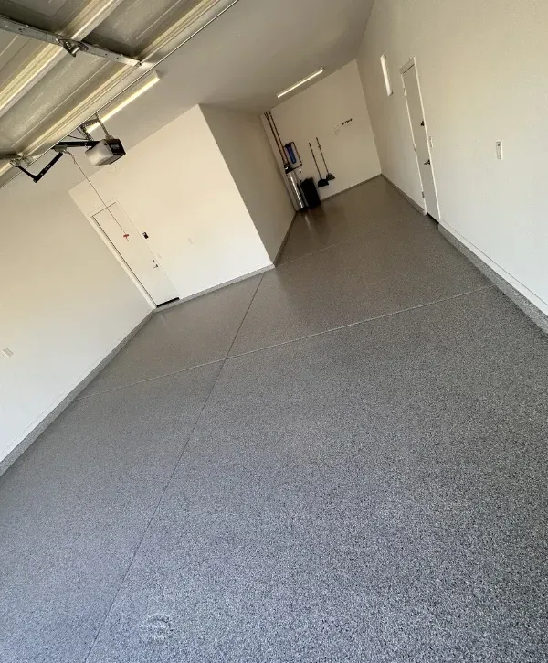 Modern garage interior featuring a durable epoxy-coated floor surface.