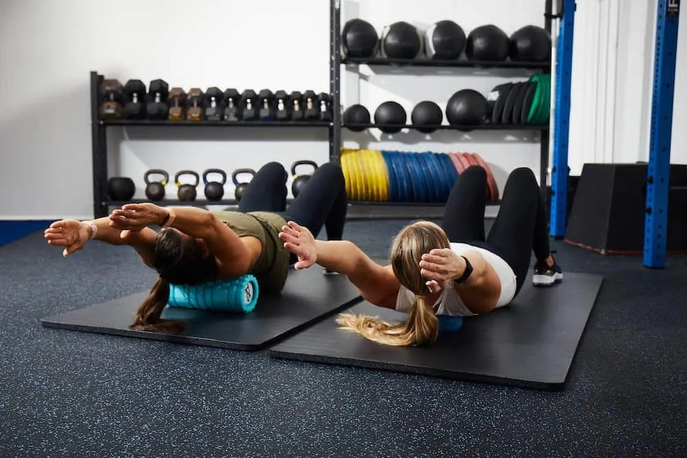 Athletes using foam rollers during mobility session to improve movement and reduce stiffness