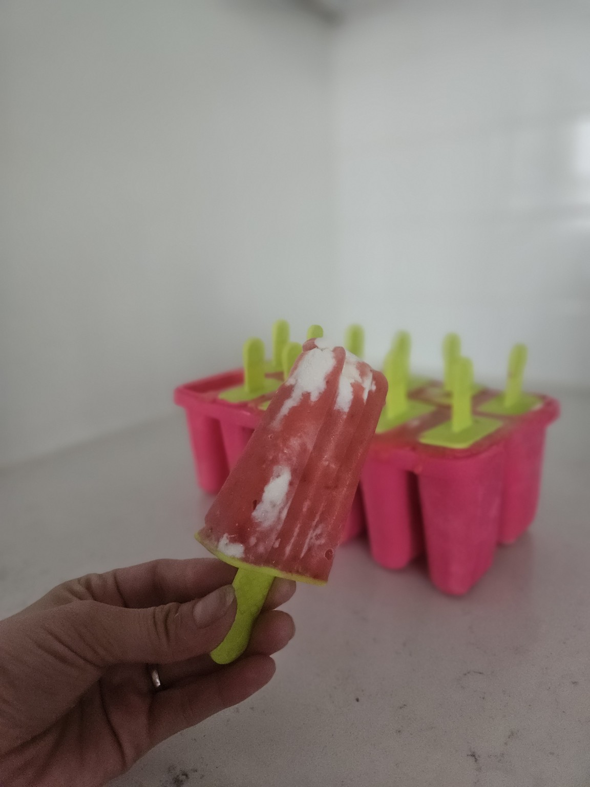 Homemade strawberry cream popsicle with creamy vanilla swirls inspired by a classic orange cream ice cream bar.