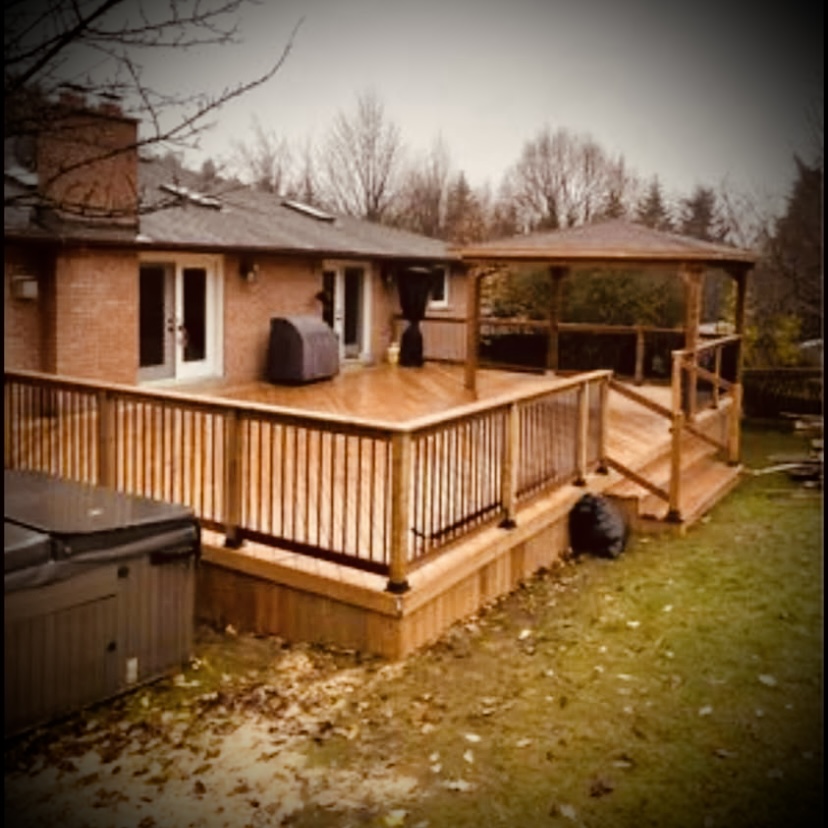 Custom pressure-treated deck build in Fredericton backyard