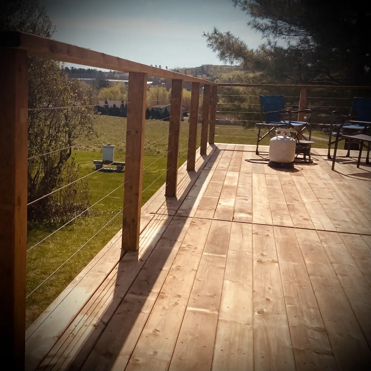 Custom pressure-treated deck build in Fredericton backyard