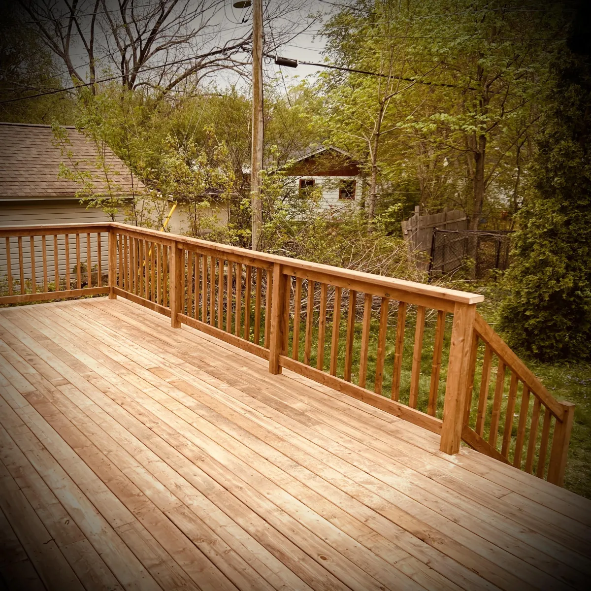 Custom pressure-treated deck build in Fredericton backyard