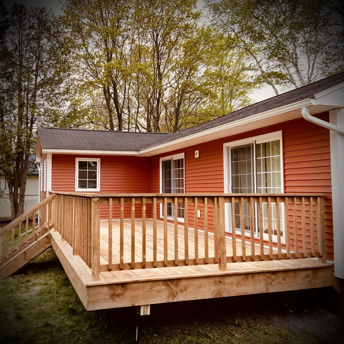 Custom pressure-treated deck build in Fredericton backyard