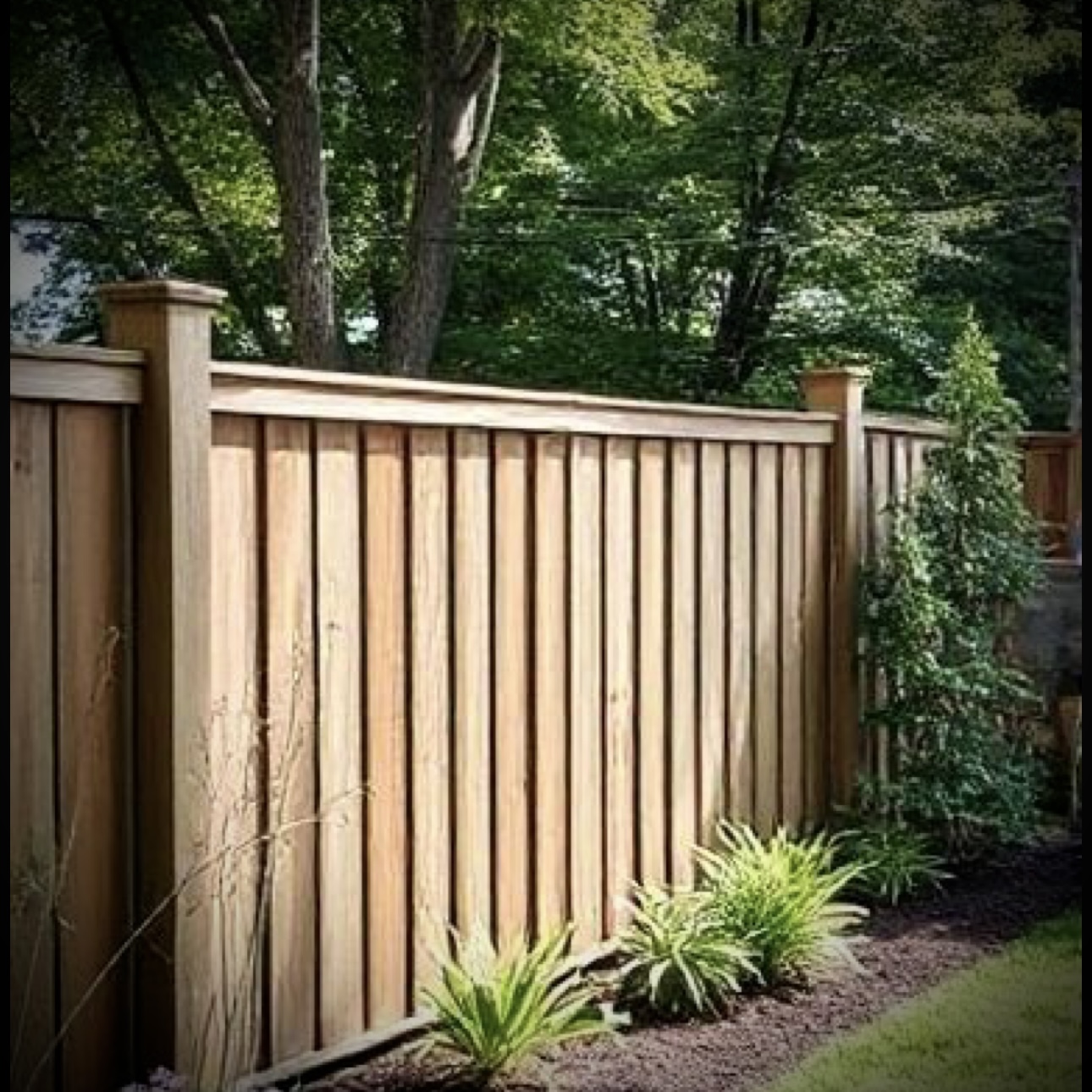 Privacy fence installation in Fredericton backyard with wood panels