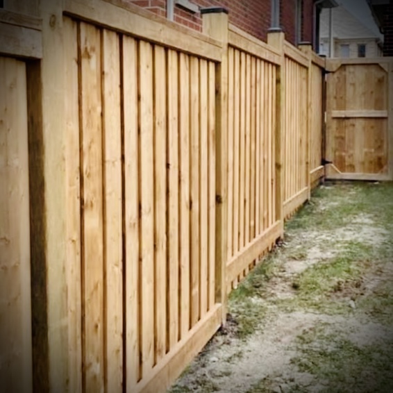Privacy fence installation in Fredericton backyard with wood panels