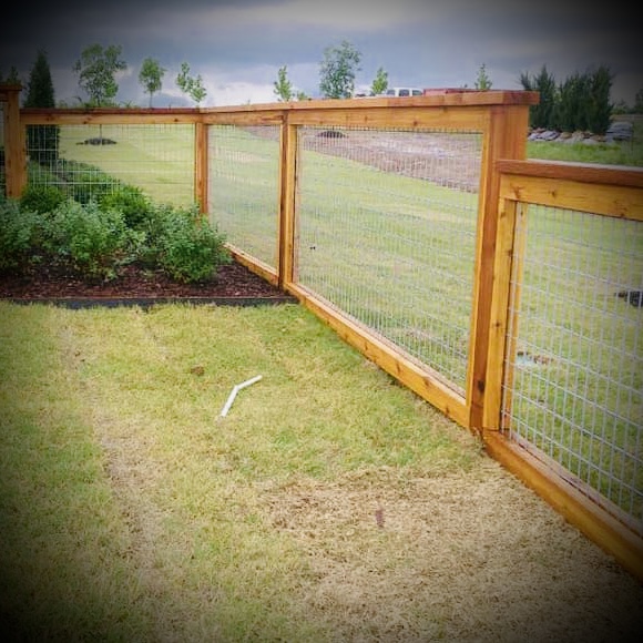 Privacy fence installation in Fredericton backyard with wood panels
