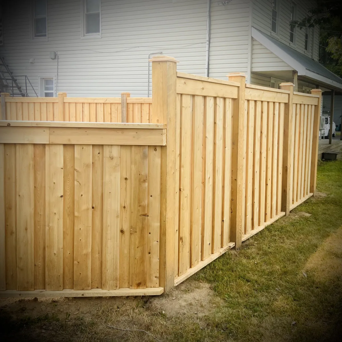 Privacy fence installation in Fredericton backyard with wood panels
