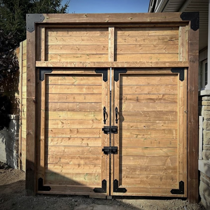 Privacy fence installation in Fredericton backyard with wood panels