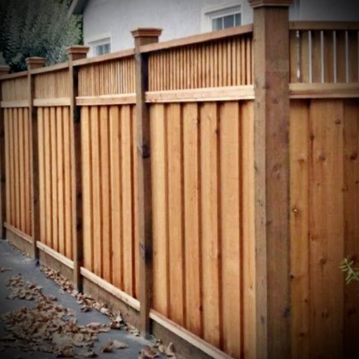 Privacy fence installation in Fredericton backyard with wood panels