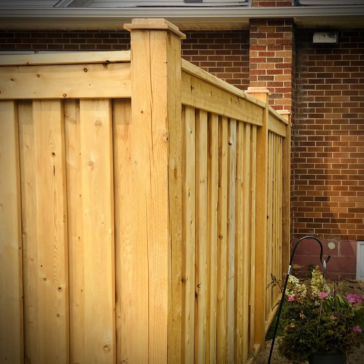 Privacy fence installation in Fredericton backyard with wood panels