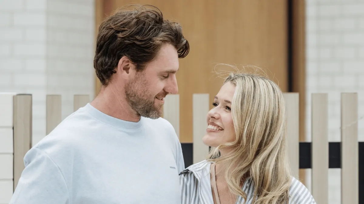Couple standing together outside their home representing financial protection planning and being prepared for life’s unexpected moments in Australia.