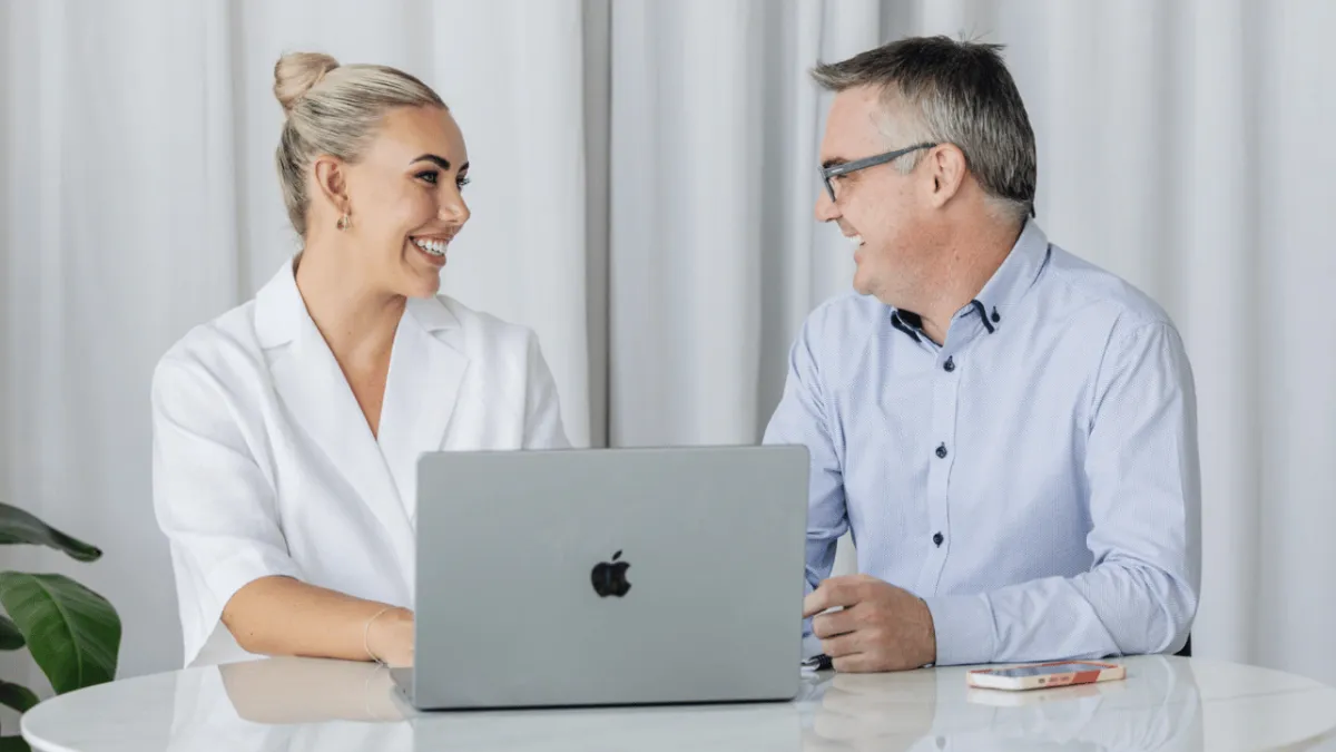 Two people discussing insurance options and learning how different types of cover support financial protection