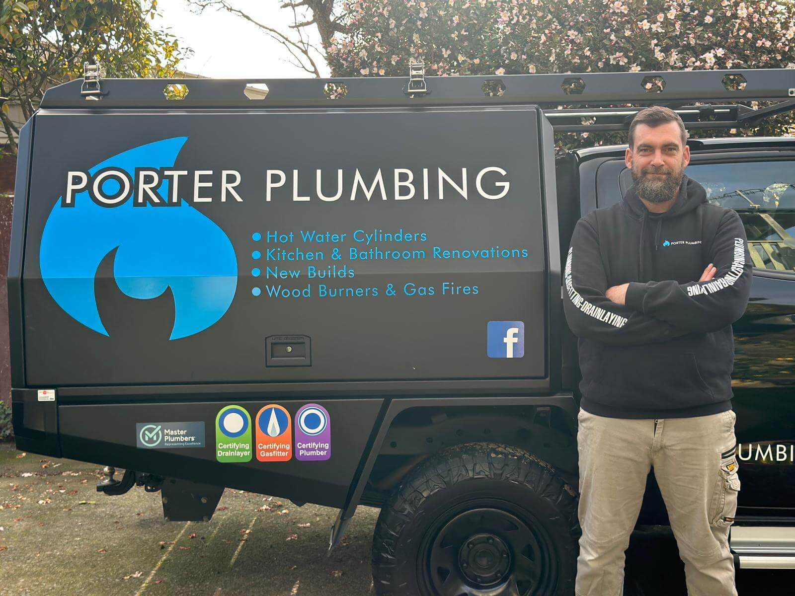 Porter Plumbing Lower Hutt plumber standing beside branded service vehicle