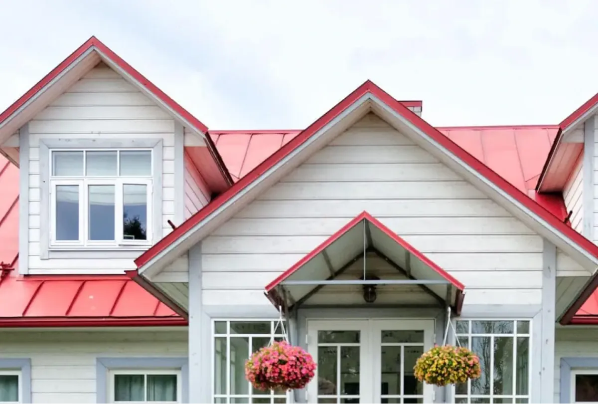 a house with a red metal roofing