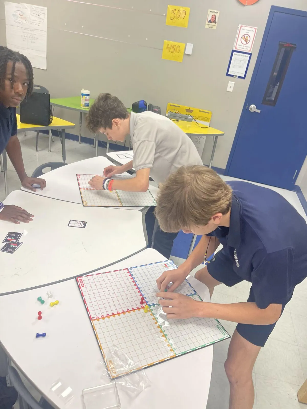 Students practicing graphing points on the Plot This! board