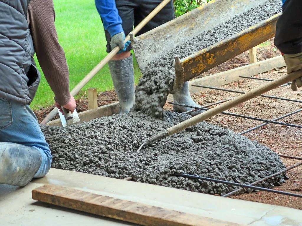 Freshly poured concrete driveway with control joints in Denton TX