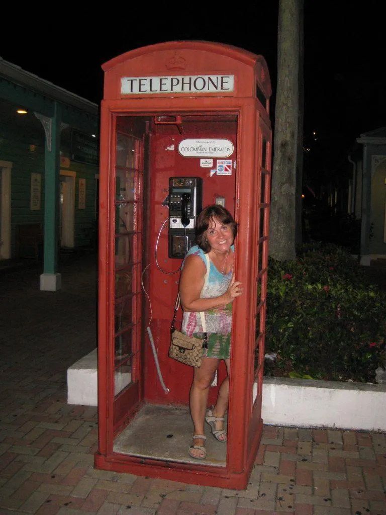 Photo of Jodie peeking out of an "old Time" phone booth