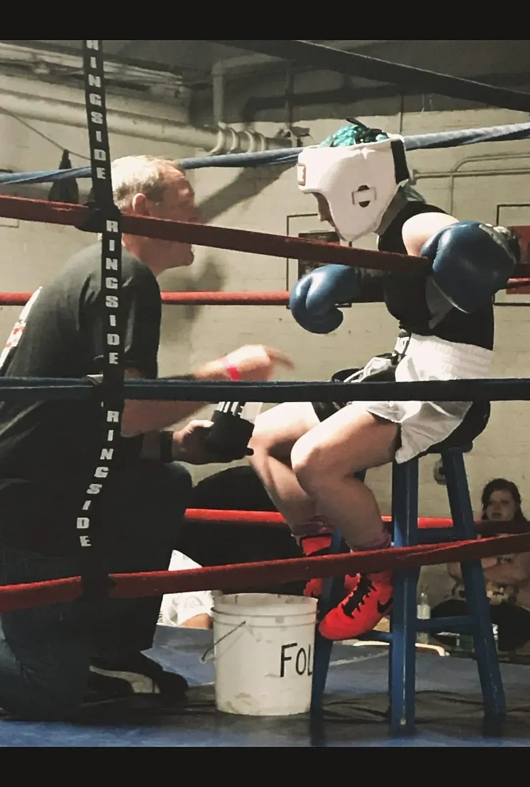 amateur boxer gym being coached by Fort Collins Boxing Coach Shane Swartz during her first boxing match